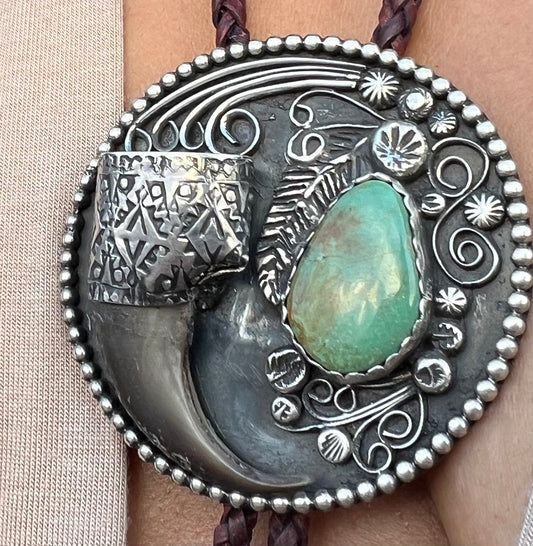 Sterling silver and Royston turquoise black bear claw bolo.