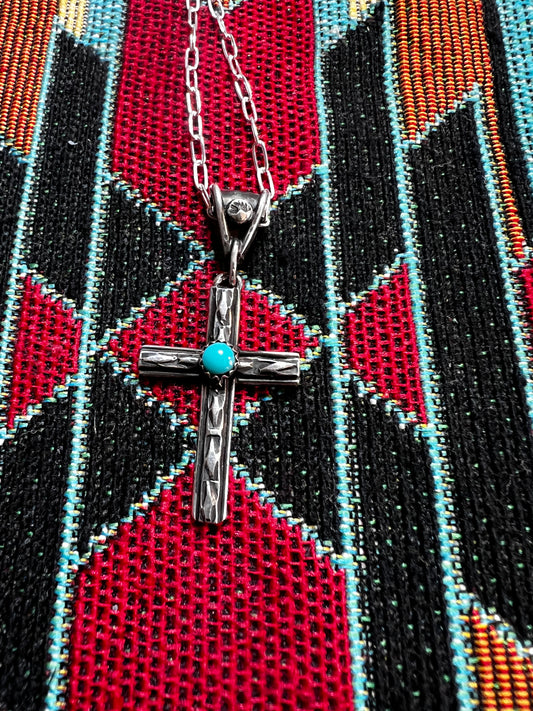 Handmade sterling silver cross with Apache turquoise. 18” Sterling silver chain included.