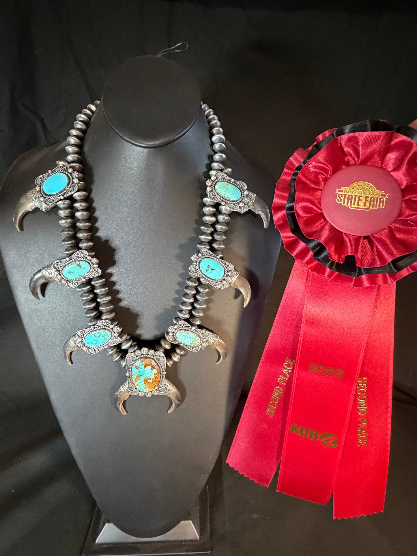 Sterling silver, King’s Manassas’s turquoise and black bear claw squash blossom