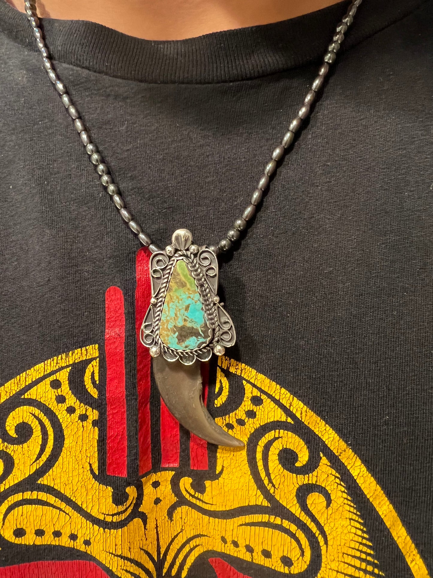 Sterling silver, and Tyrone turquoise blackbear claw pendant ￼