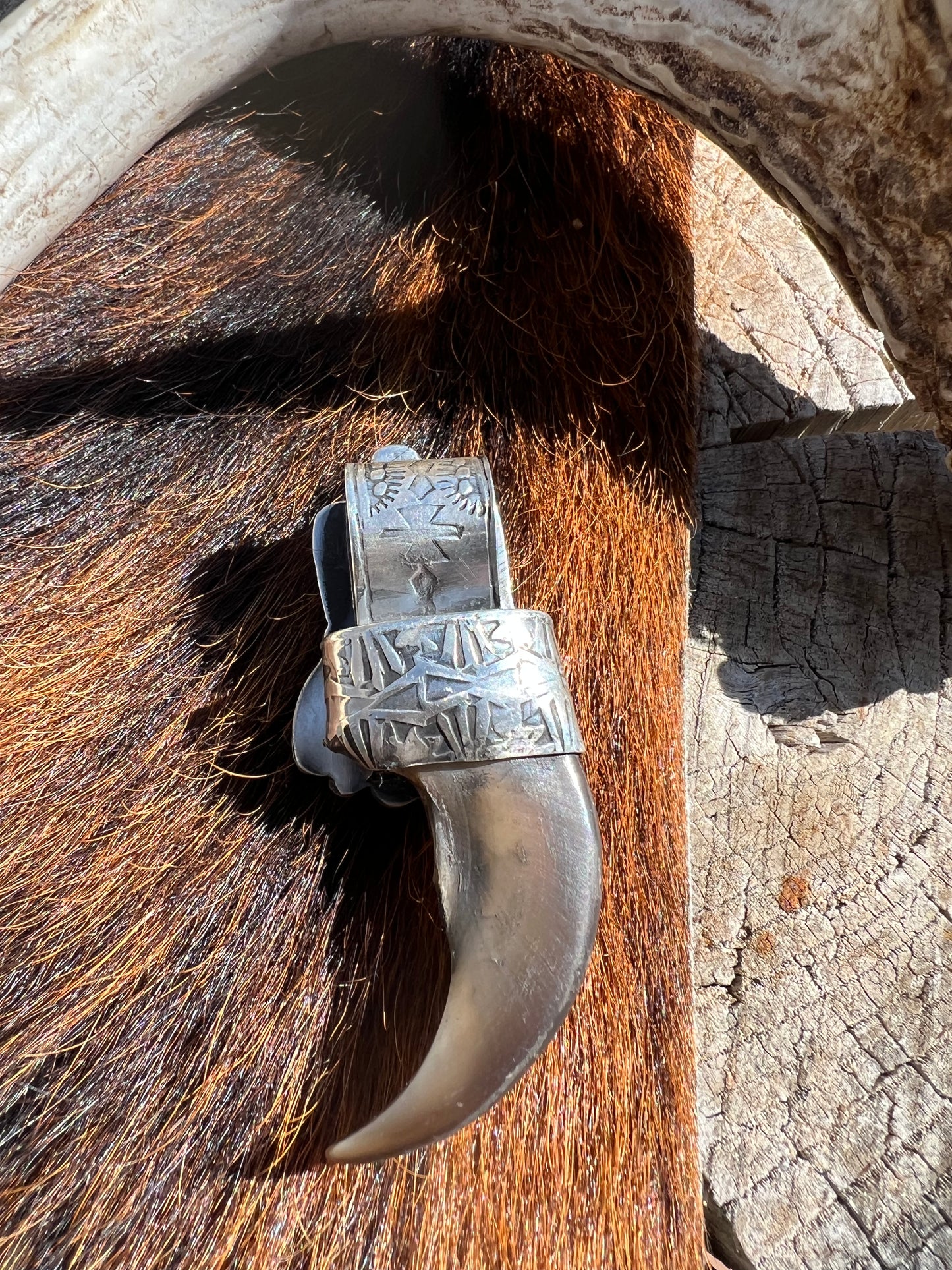 Sterling silver, and Tyrone turquoise blackbear claw pendant ￼