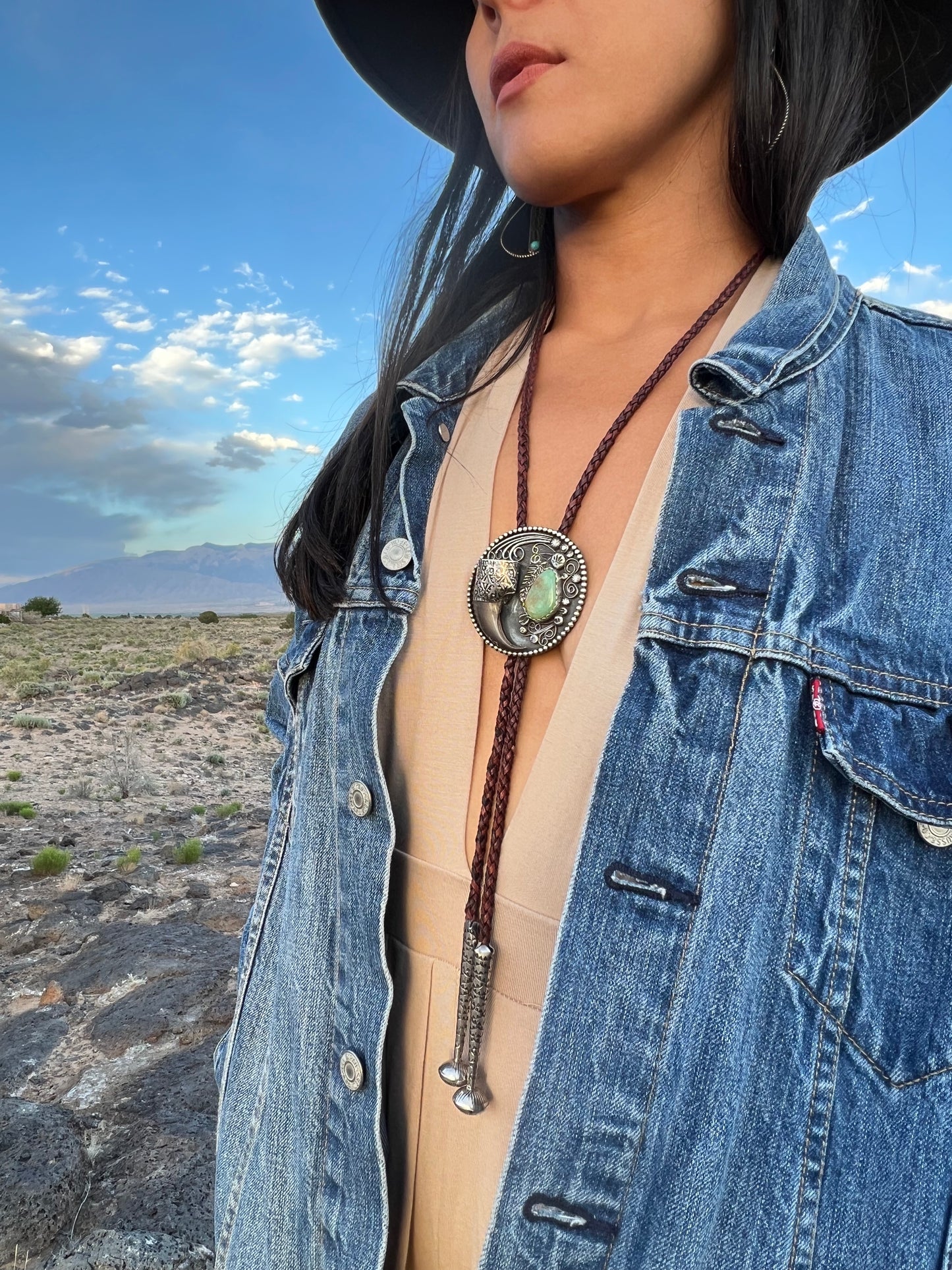 Sterling silver and Royston turquoise black bear claw bolo.