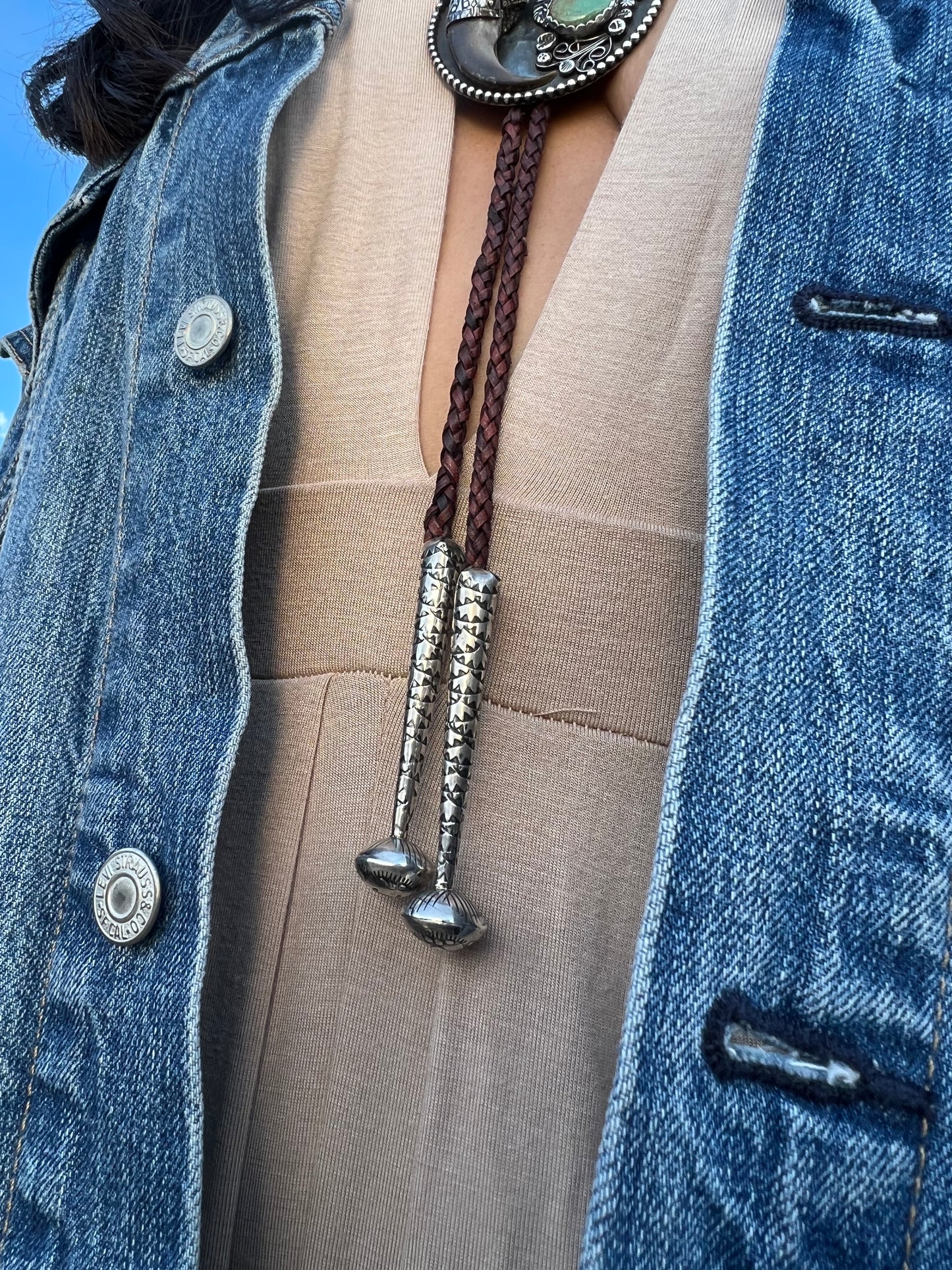 Sterling silver and Royston turquoise black bear claw bolo.