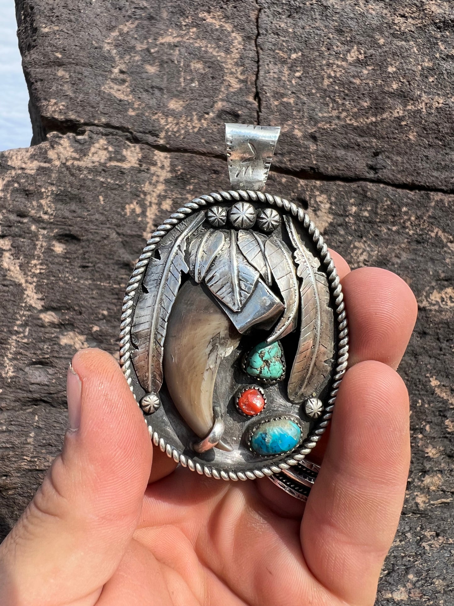 Sterling silver, bear claw, turquoise, and coral pendant