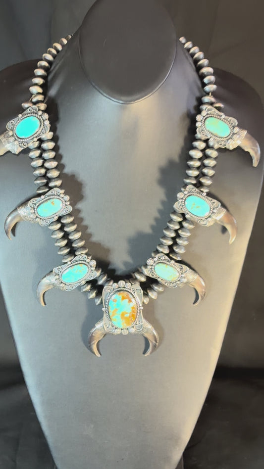 Sterling silver, King’s Manassas’s turquoise and black bear claw squash blossom